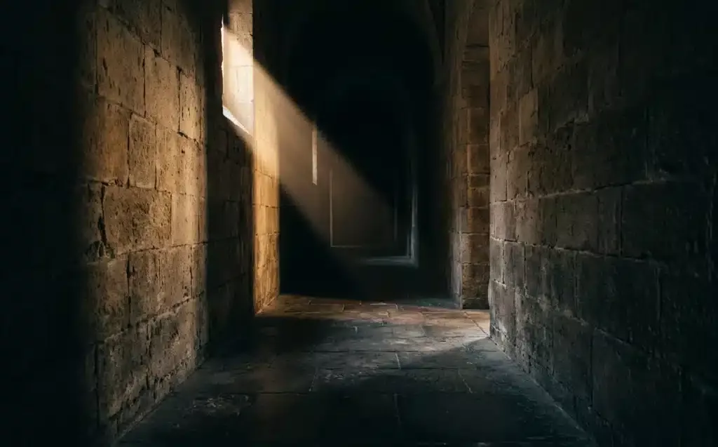 érosion spirituelle en milieu toxique — couloir sombre symbolisant l'espace comprimé de la foi